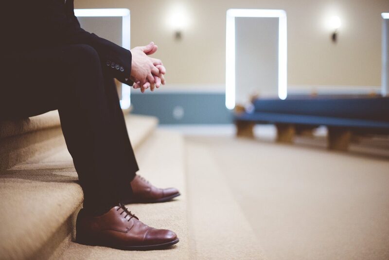 A man seated in the meeting hall